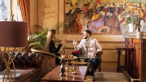 A cozy lounge area with leather sofas, a coffee table with decorative items, and a large painting on the wall. - Hôtel & Spa Saint Jacques (Paris)