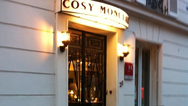 A building with a sign reading "COSY MONCEAU" and a black metal gate. There are two potted plants in front. - Hôtel Cosy Monceau (Paris)