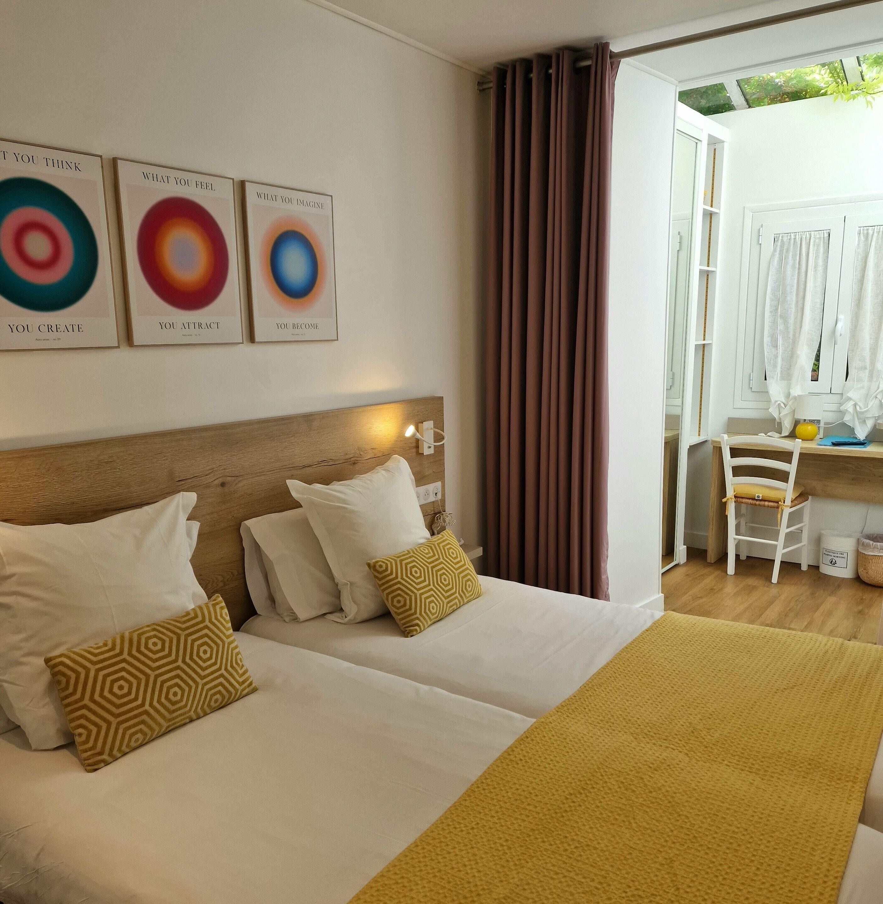Een hotelkamer met een bed, kussens, een hoofdeinde en een bureau met stoel.
