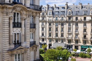 A historic building with ornate architectural details, multiple balconies, and a classic facade. - Le 46 Hotel (Paris)