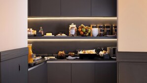 A breakfast bar with various food items and condiments. - Le 46 Hotel (Paris)