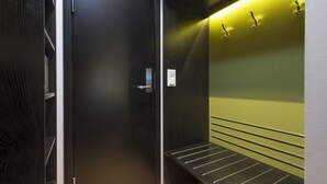 A modern elevator with a metallic handrail and a green wall. - Thon Hotel Vika Atrium (Oslo)