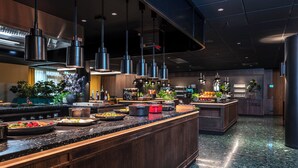 A modern kitchen with granite countertops, stainless steel appliances, and hanging pendant lights. - Thon Hotel Vika Atrium (Oslo)