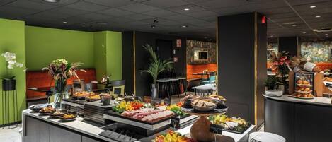 A buffet area with various food options, a seating area, and a counter with a cash register.