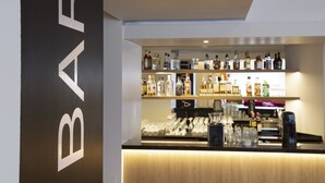 A bar area with shelves of liquor bottles and glasses. - Thon Hotel Bergen Airport (Bergen)