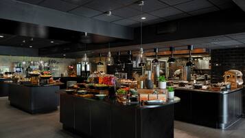 A modern kitchen with multiple islands, equipped with various appliances and utensils.