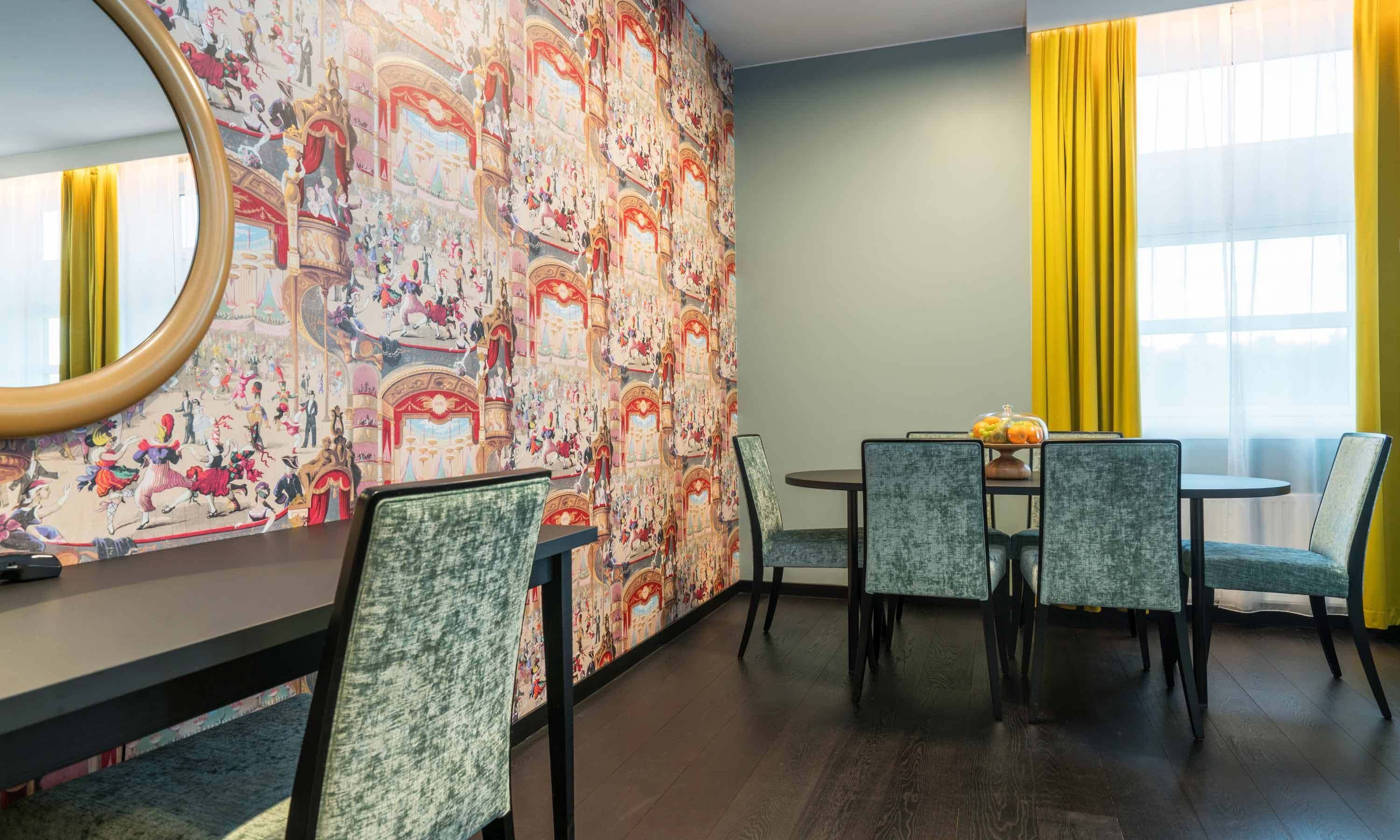 A dining area with a table, chairs, and a mirror.