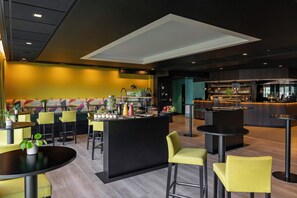A modern bar area with seating and a bar counter.