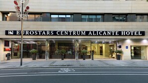The exterior of the Eurostars Centrum Alicante Hotel with a modern facade, large glass windows, and a prominent entrance.