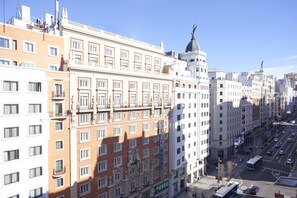 A multi-story hotel with a classic architectural style, featuring balconies and large windows.