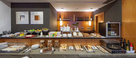 A buffet setup with various food items, a refrigerator, and a wine rack.