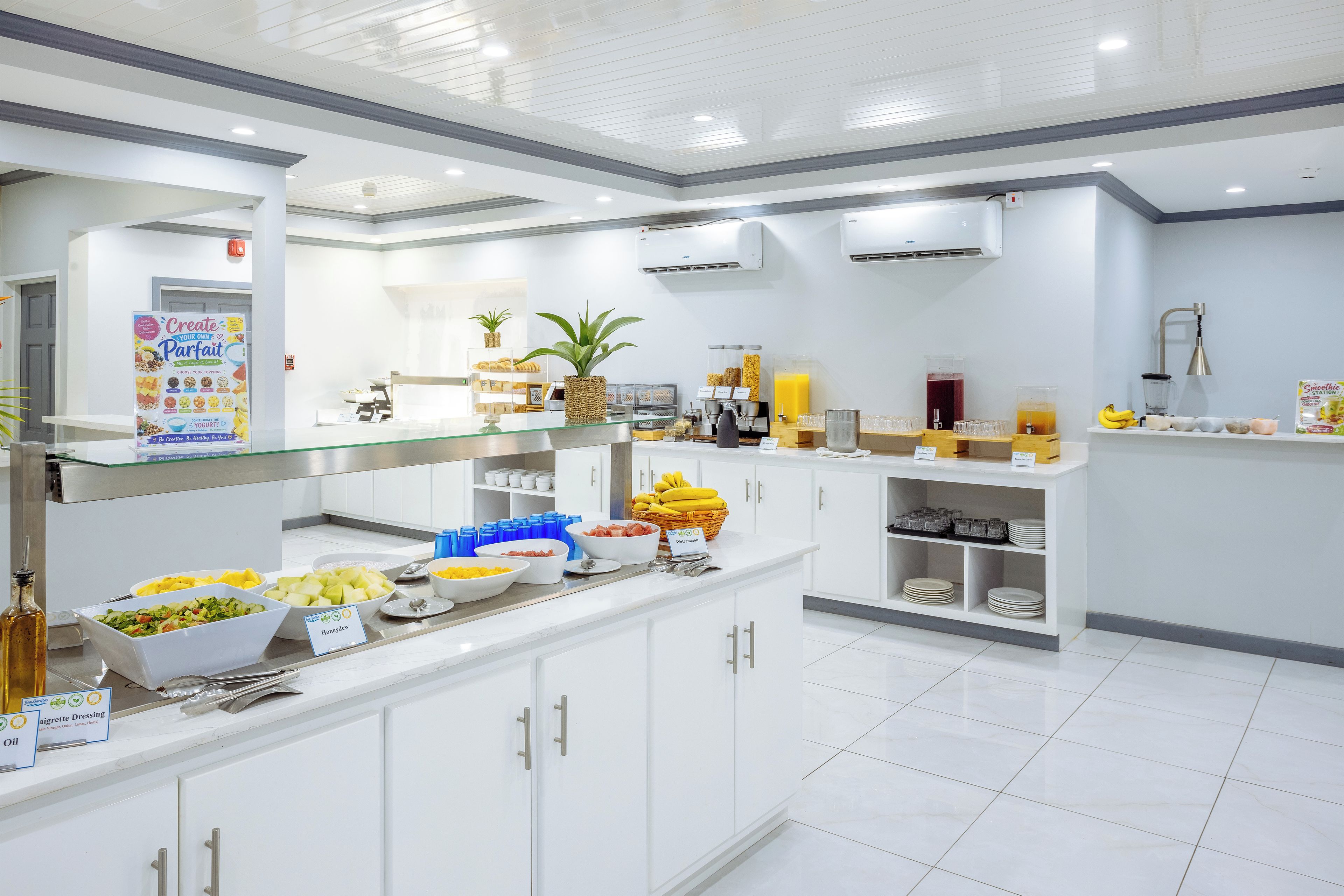A modern kitchen with white cabinets, a variety of food items, and a clean, organized layout.
