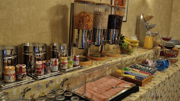 Una mesa de buffet con distintos alimentos y salsas.