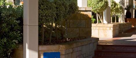 A hotel entrance with a sign for Novotel Vines Resort.