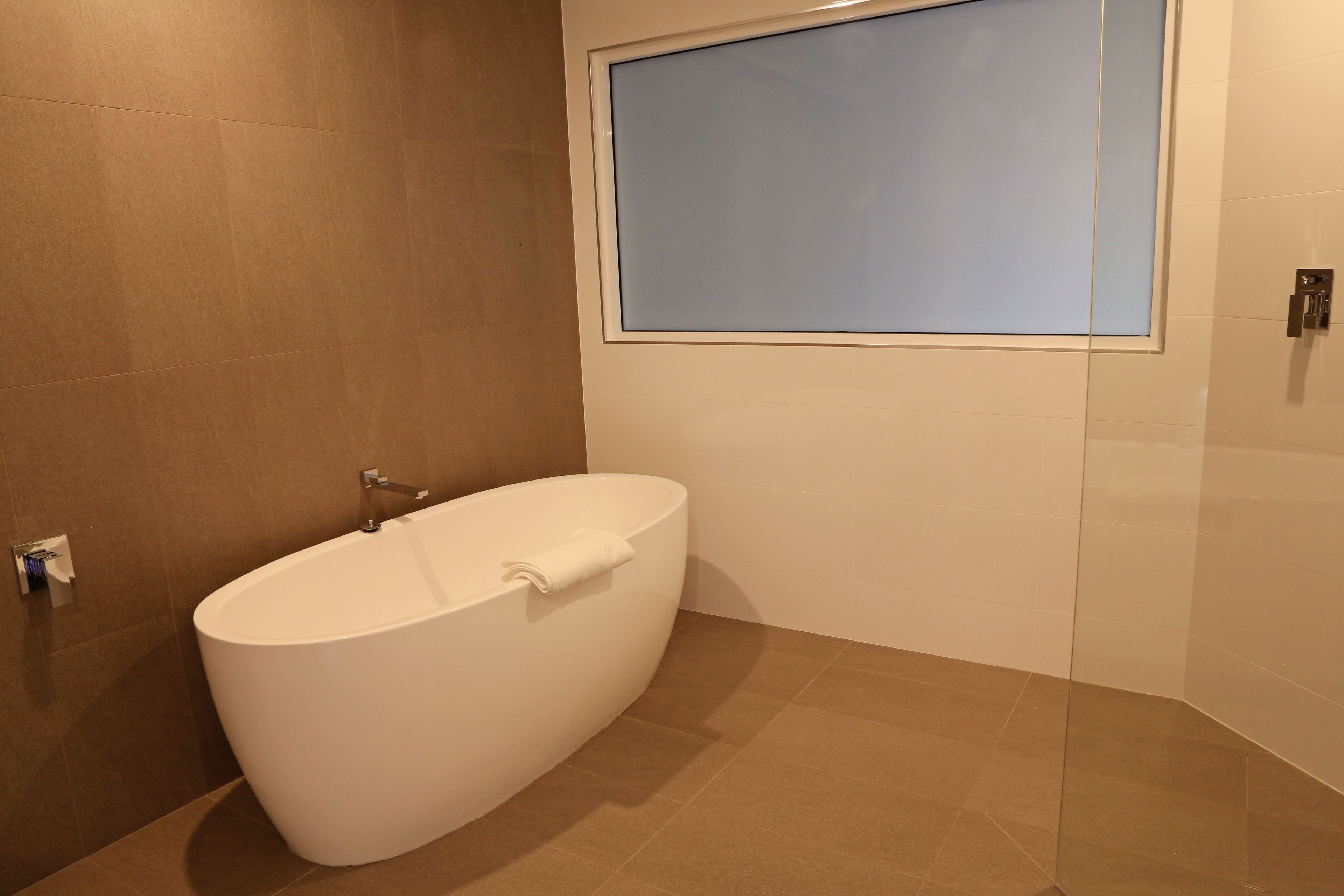 deluxe room, 1 king bed | bathroom | shower, eco-friendly toiletries, hair dryer, towels