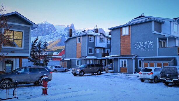 A multi-story building with a sign reading "Canadian Rockies Chalet." - Canadian Rockies Chalets by Trilink (Canmore)