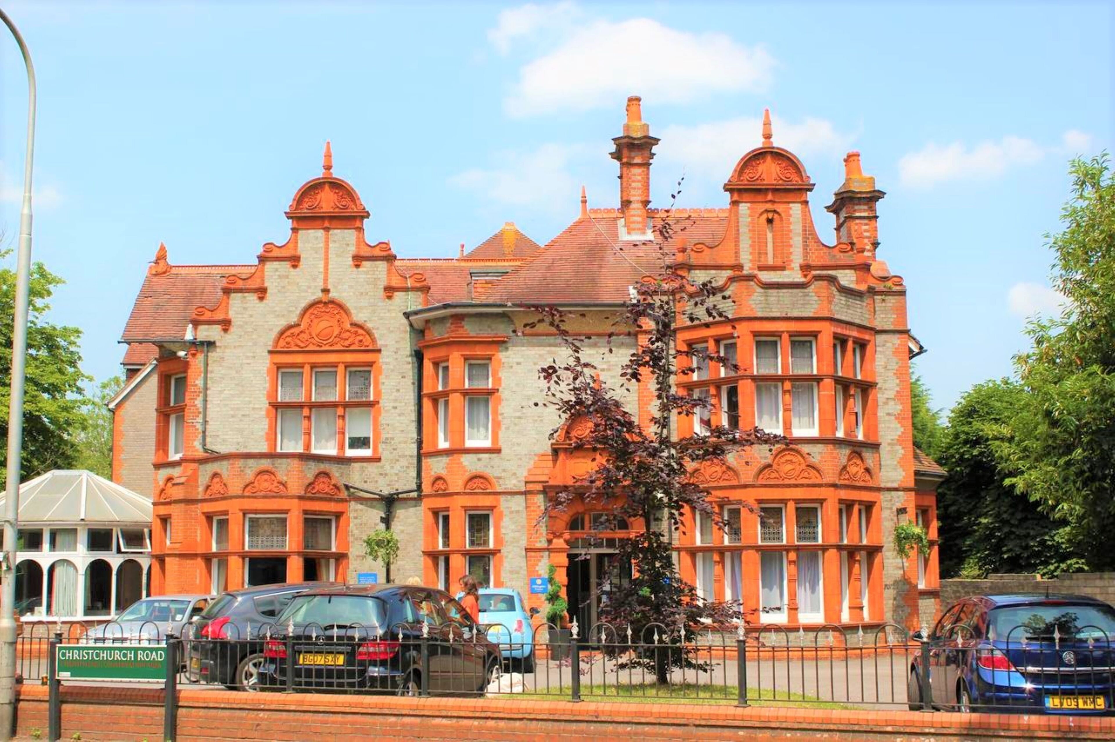 A large, ornate building with multiple windows and a prominent entrance.