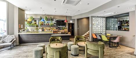 A modern hotel lobby with a bar area, seating, and a display of shoes.