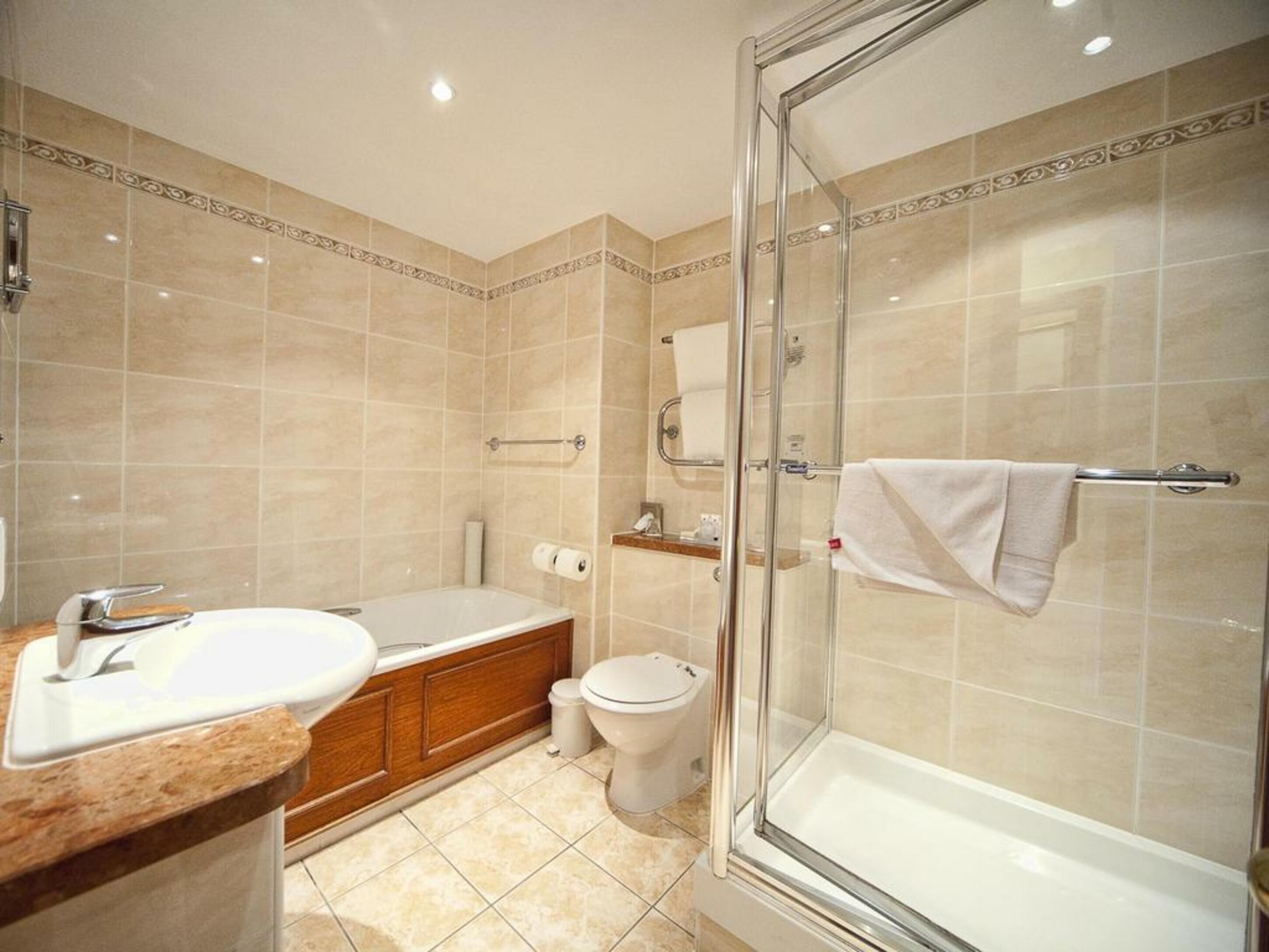 separate bathtub and shower, designer toiletries, hair dryer, towels