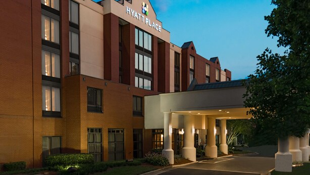 A multi-story hotel with a prominent 'Hyatt Place' sign, a covered entrance, and a landscaped driveway. - Hyatt Place Atlanta/Duluth/Johns Creek (Johns Creek)