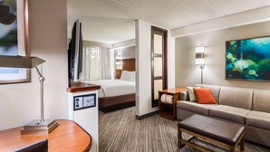 A hotel room with a bed, a sofa, a desk, and a TV. - Hyatt Place Atlanta/Duluth/Johns Creek (Johns Creek)