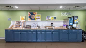 A self-service breakfast station with a variety of food options, a coffee machine, and a refrigerator.