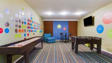 Relax in a vibrant space with a foosball table, pool table, and flat-screen TV.