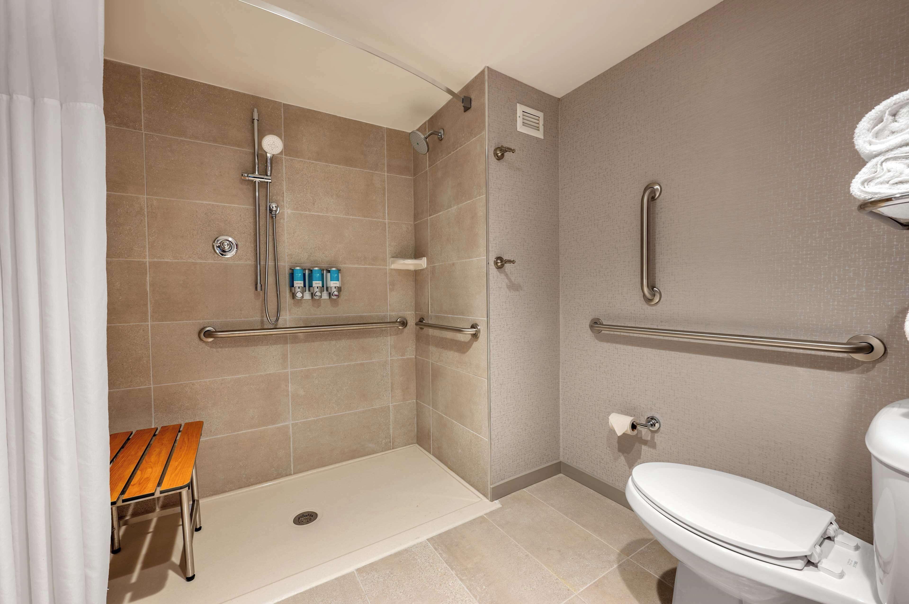 deluxe room, 1 king bed, accessible, refrigerator & microwave (roll in shower) | bathroom | combined shower/bathtub, free toiletries, hair dryer, towels