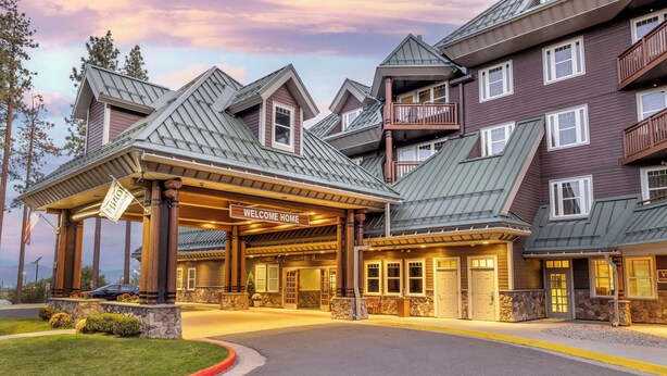 A multi-story hotel with a 'Welcome Home' sign, a covered entrance, and a stone facade. - Hilton Vacation Club Lake Tahoe Resort South (South Lake Tahoe)