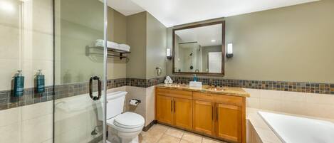 A modern bathroom with a glass shower enclosure, a white toilet, wooden cabinets, a large mirror, and a bathtub.