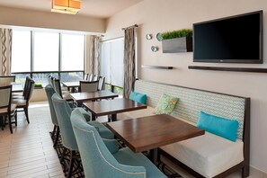 Relax in a spacious room with a large window, flat-screen TV, and cozy seating area.