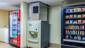 A vending machine area with a Coca-Cola cooler, an ICE cooler, and a snack vending machine.