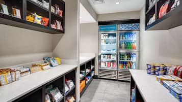 A hotel guest room with a kitchenette, a minibar, and a guest market.