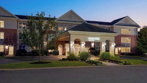A multi-story hotel with a prominent entrance, well-maintained landscaping, and a clear view of the hotel's name. - Homewood Suites by Hilton Buffalo Airport (Buffalo)