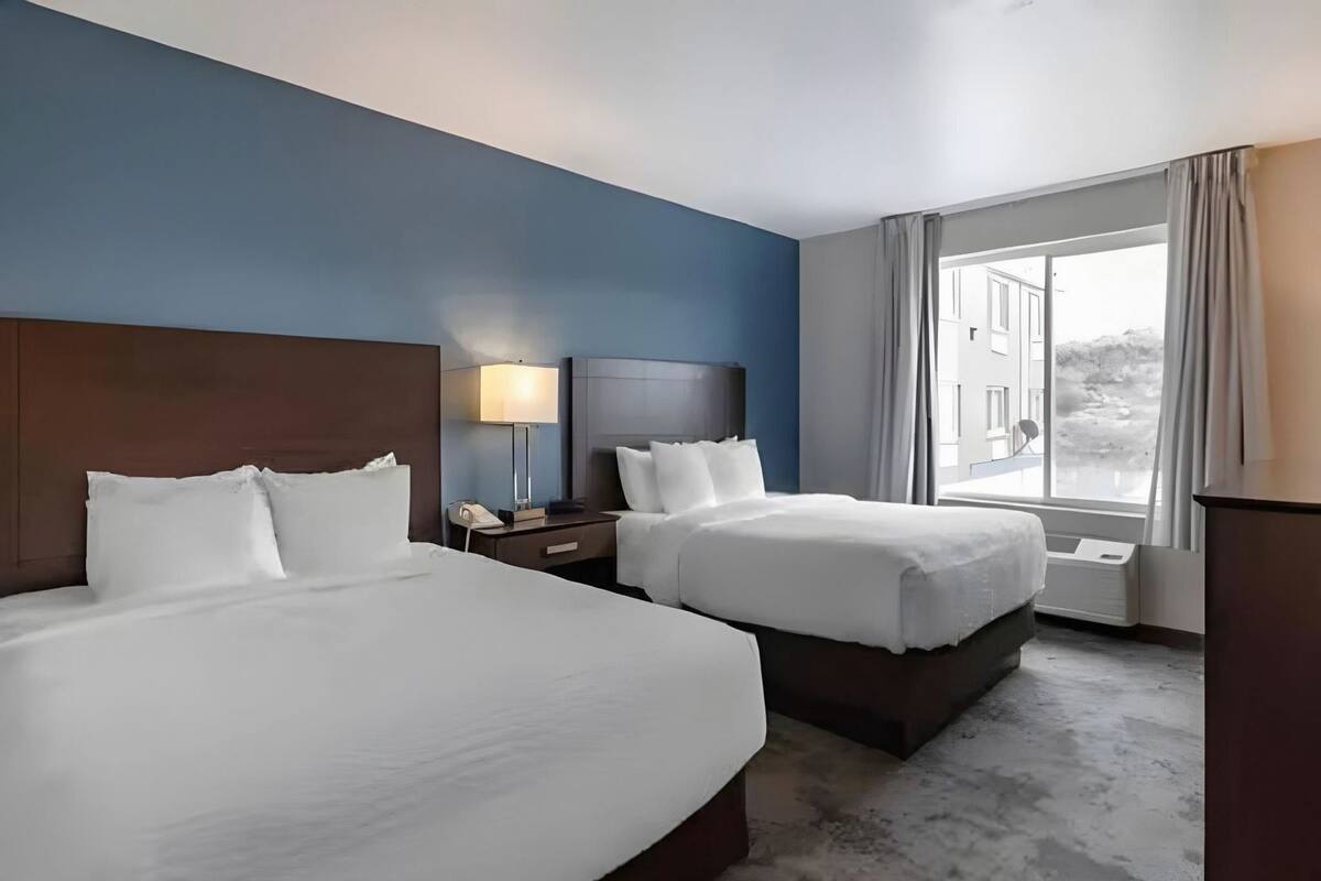 Premium bedding, pillow-top beds, desk, laptop workspace