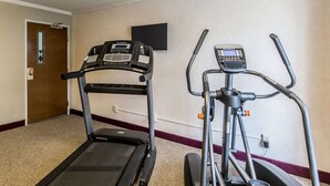 A hotel room with a treadmill and elliptical machine. - Quality Inn & Suites Evansville North (Evansville)