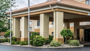 A hotel entrance with a covered walkway, columns, and numbered doors. - Quality Inn & Suites Evansville North (Evansville)