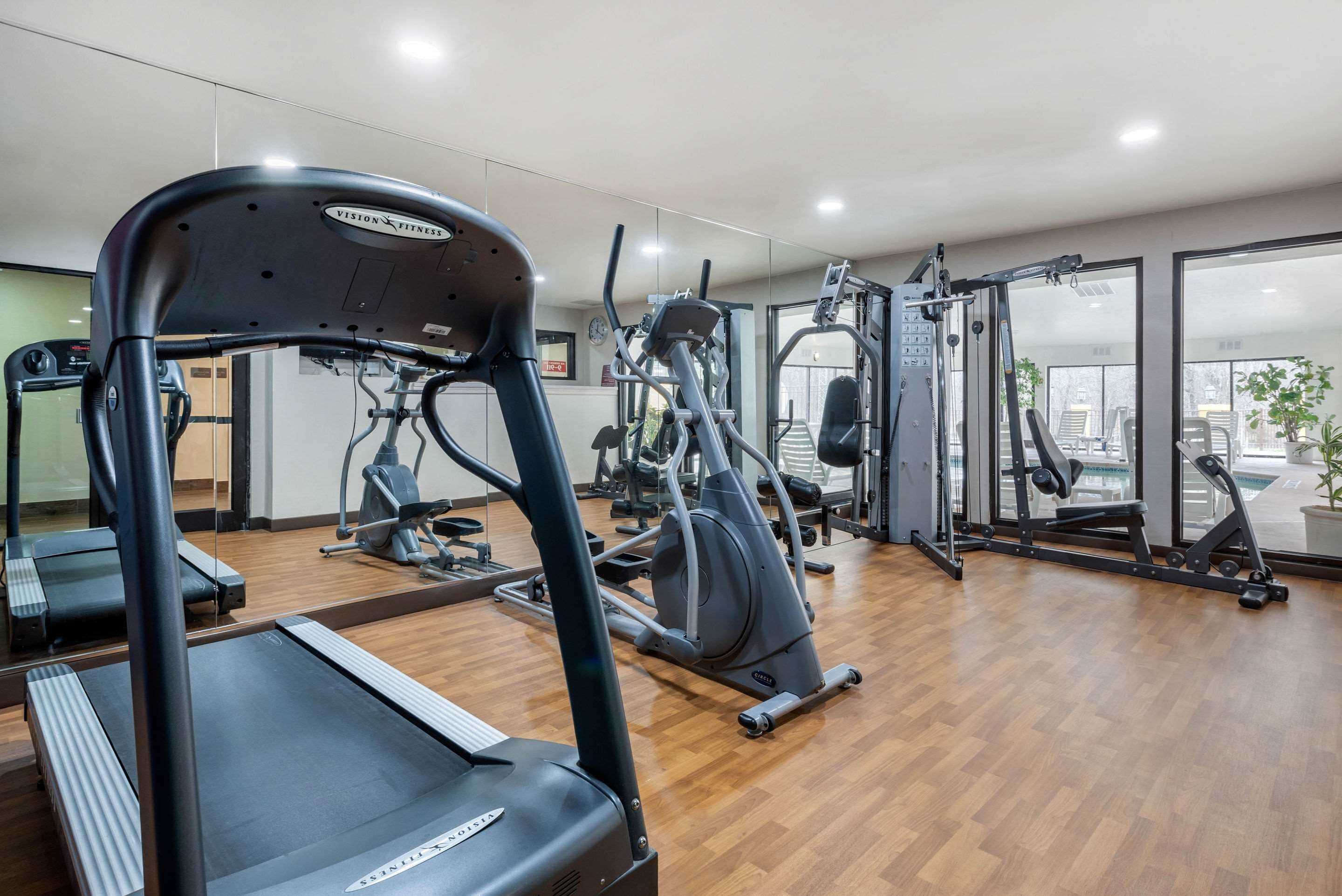 A gym with treadmills, elliptical machines, and weight equipment.