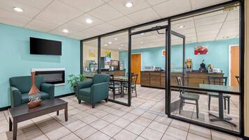 A modern interior with a seating area, a kitchen, and a dining space.