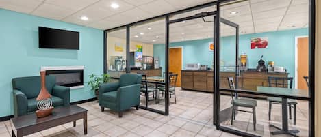 A modern interior with a seating area, a kitchen, and a dining space.