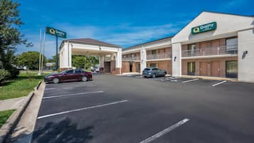 A Quality Inn hotel with a covered parking area and a two-story building.