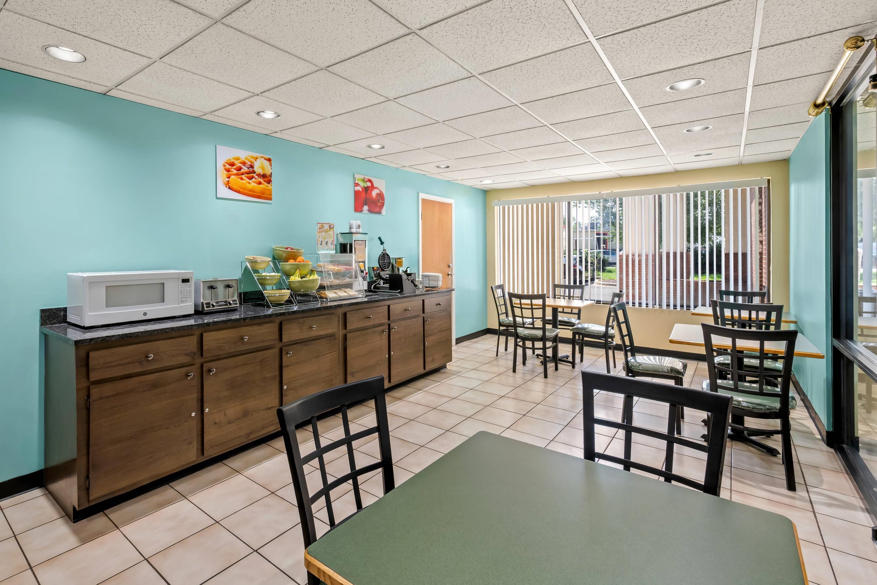 A clean, well-lit cafe with a counter, seating area, and a view of the outdoors.