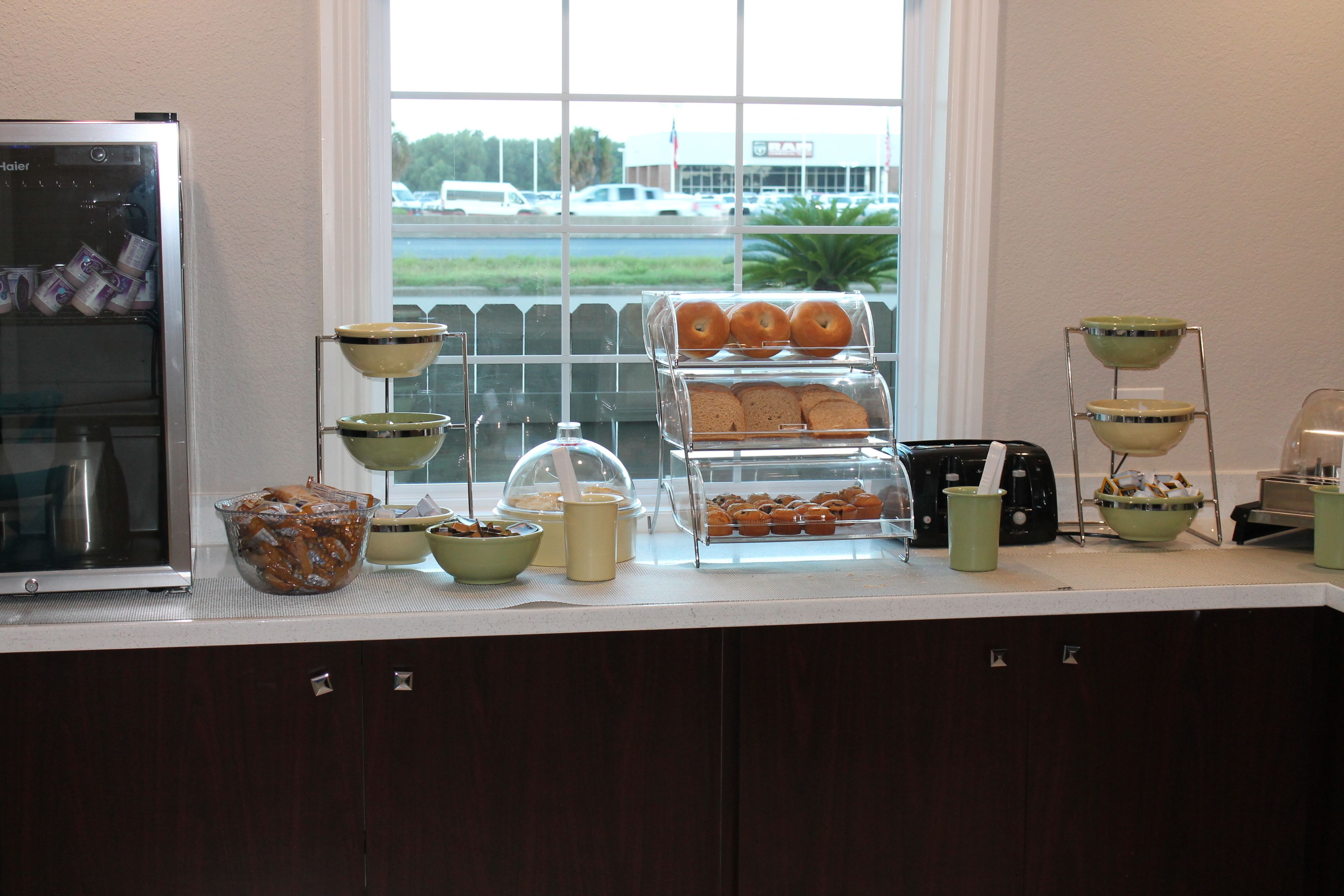 A breakfast buffet with various food items and a refrigerator.