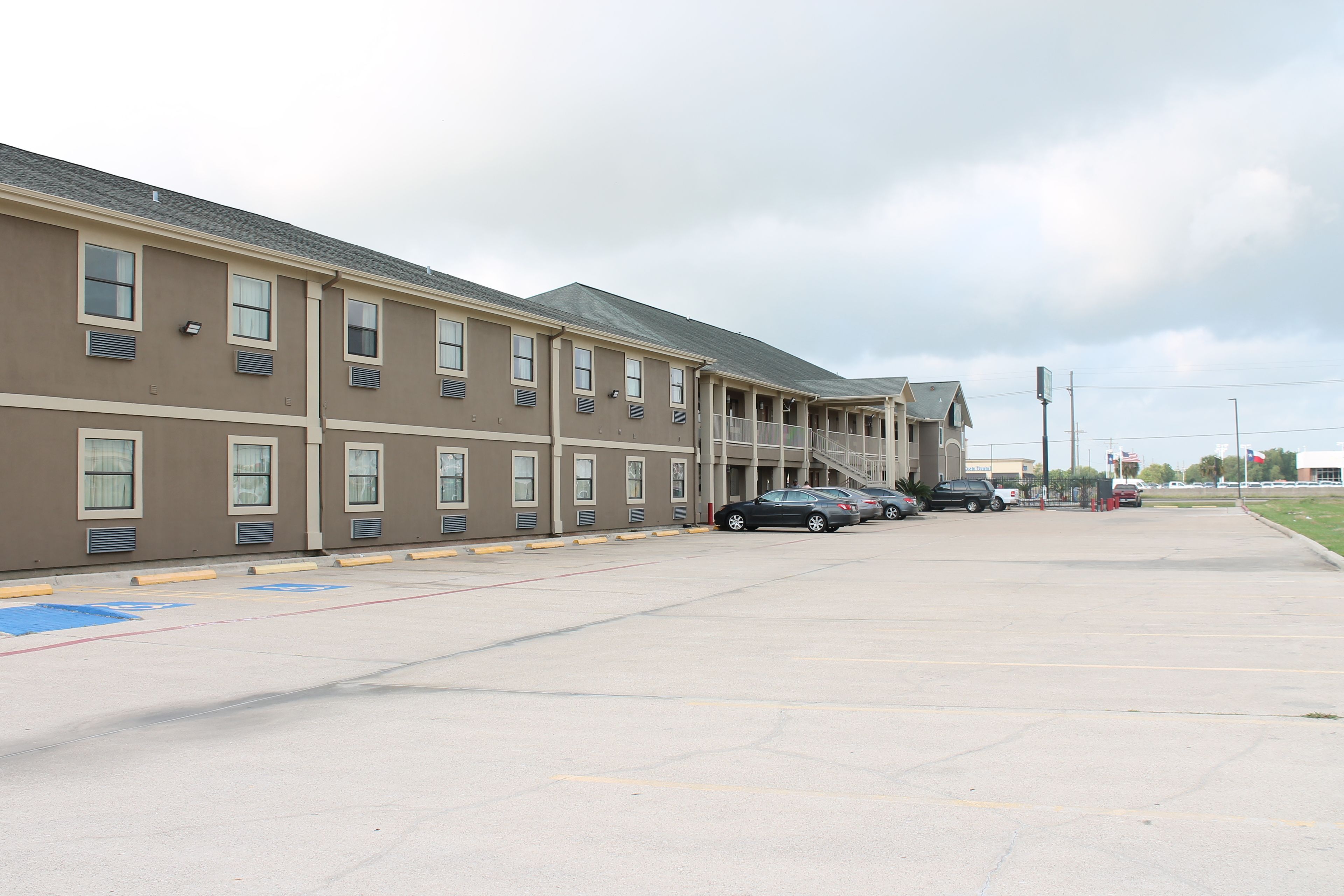 A multi-story parking garage with several cars parked.