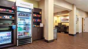A hotel lobby with a Marketplace, refrigerated display cases, and a reception area. - Comfort Suites NW Dallas Near Love Field (Dallas)