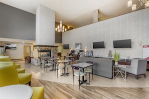 A modern hotel lobby with a bar area, seating arrangements, and a fireplace. - Best Western Plus Wenatchee Downtown Hotel (Wenatchee)