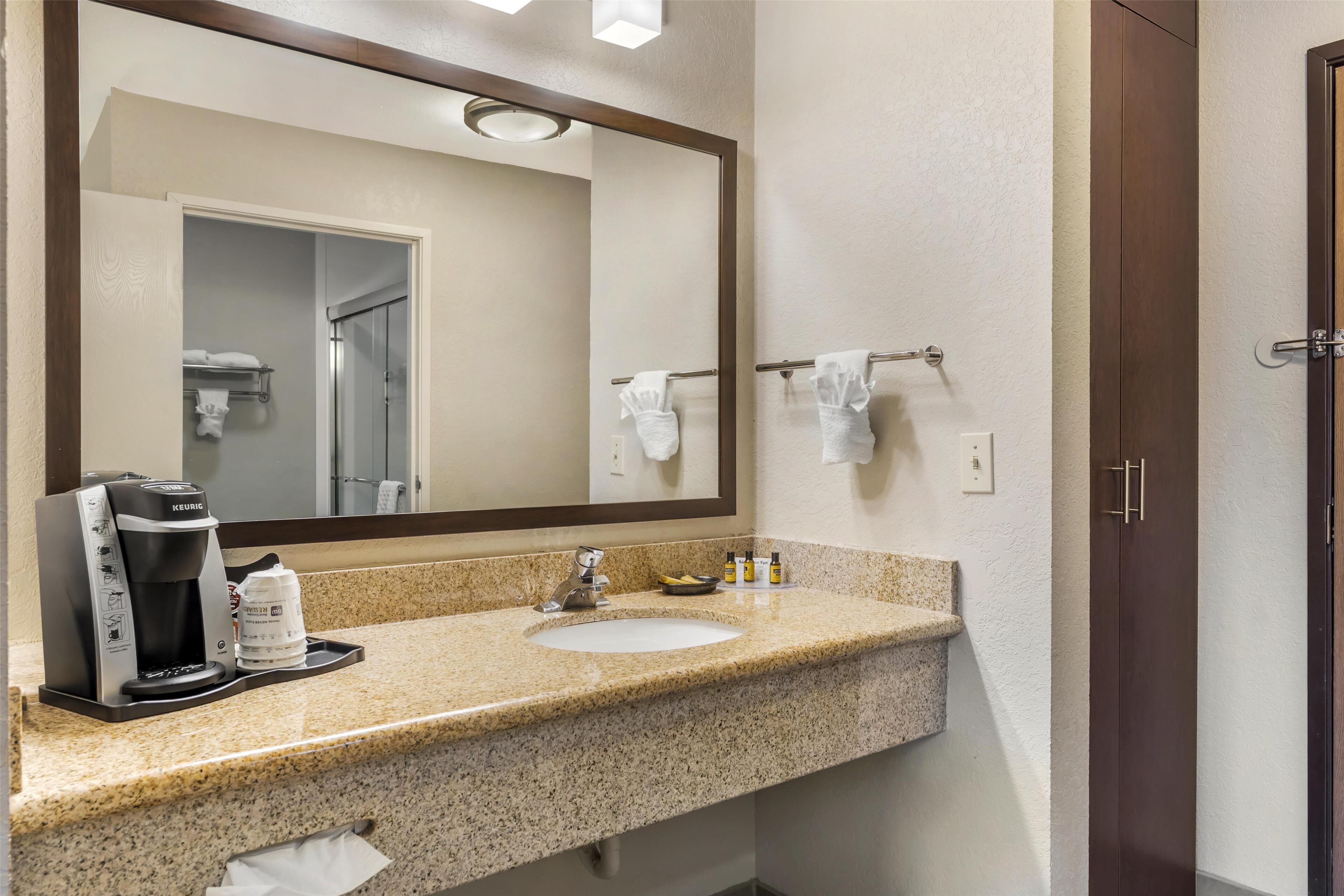 suite, 1 king bed, non smoking, microwave | bathroom | combined shower/bathtub, rainfall showerhead, free toiletries