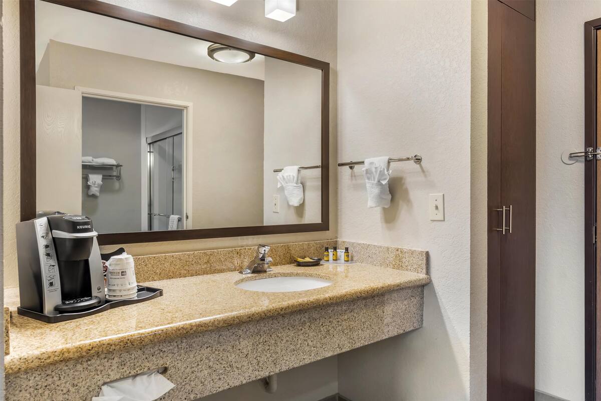 suite, 1 king bed, non smoking, microwave | bathroom | combined shower/bathtub, rainfall showerhead, free toiletries