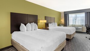 A hotel room with two beds, a desk, a chair, and a window with curtains. - Best Western Plus Wenatchee Downtown Hotel (Wenatchee)