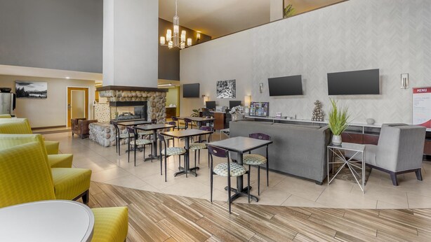 A modern hotel lobby with a bar area, seating arrangements, and a fireplace. - Best Western Plus Wenatchee Downtown Hotel (Wenatchee)